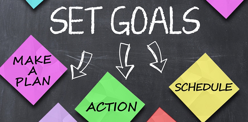 Set goals concept with colorful stickers on blackboard